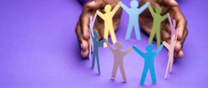 Imagine to demonstrate safeguarding: A pair of hands are cupped around a circle of paper people