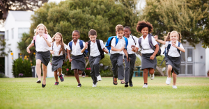 School children run in a field