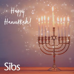 Hanukkah candles against a sparkly background