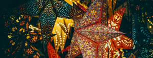 Star shaped lanterns illuminate against a dark background