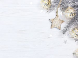 baubles and tree branches on a white sparkly background