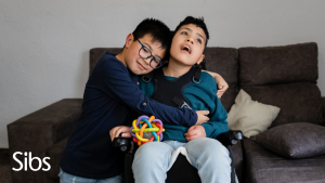 A boy hugs his disabled brother