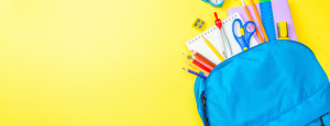The contents of a blue school bag spill onto a bright yellow background