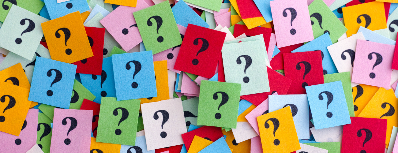 A sea of colourful sticky notes with question marks on them