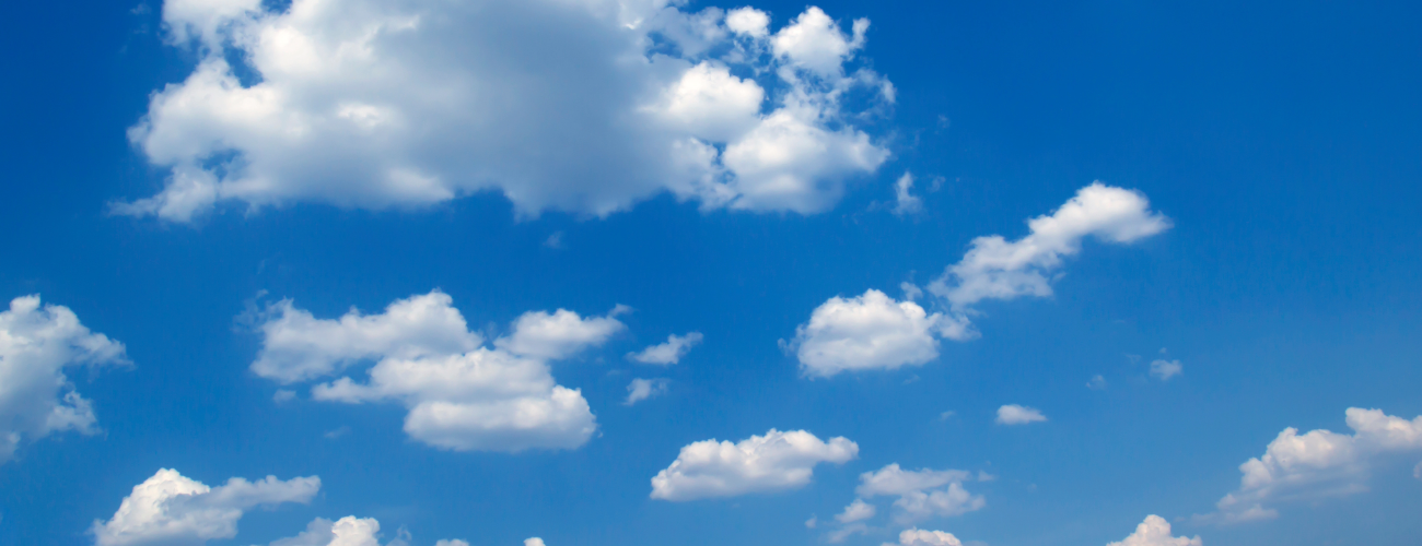 White fluffy clouds against a bright blue sky