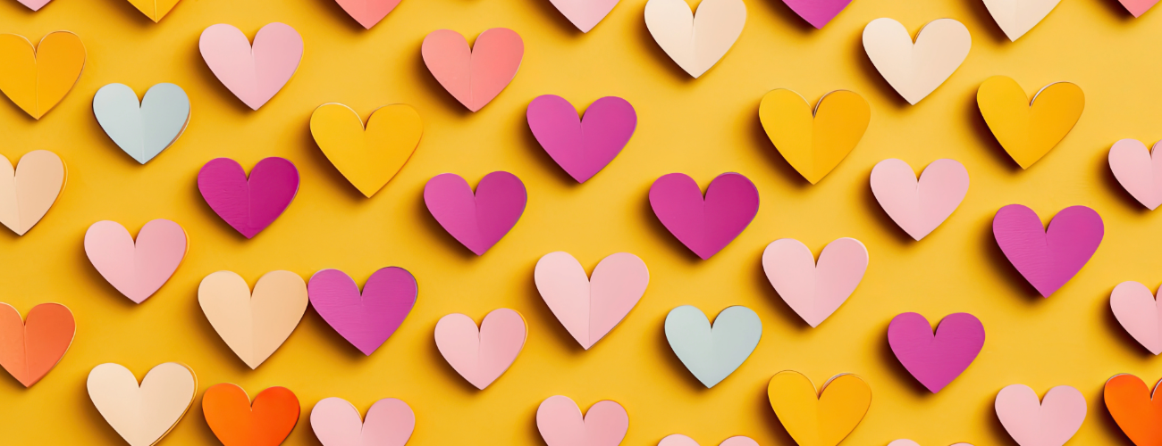 Colourful paper hearts against a yellow background