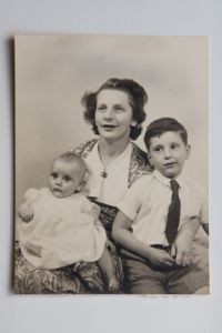 Black and white photograph of Liz with her autistic brother Lionel, both sat with their mother