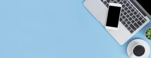 Laptop and phone against a blue background